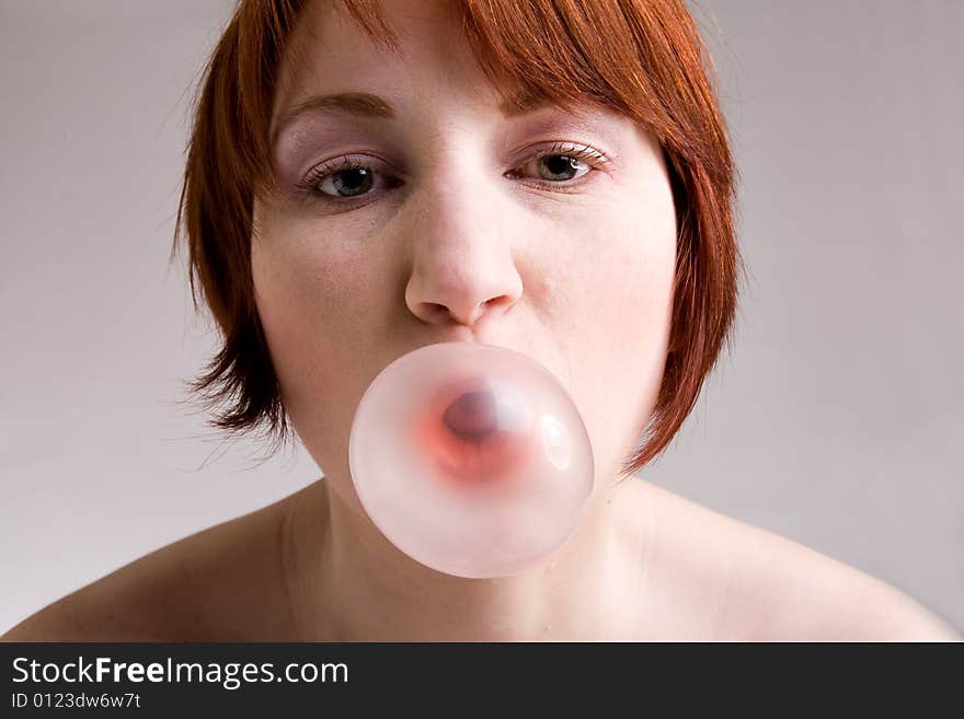 Red haired girl is eating fresh bubblegum. Red haired girl is eating fresh bubblegum