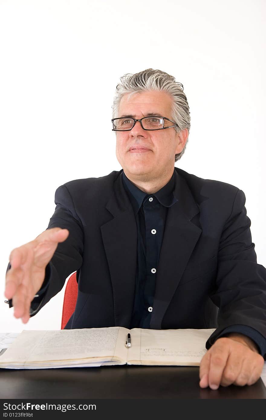 A businessman at work in his office in moment of the day. offering hand for shaking