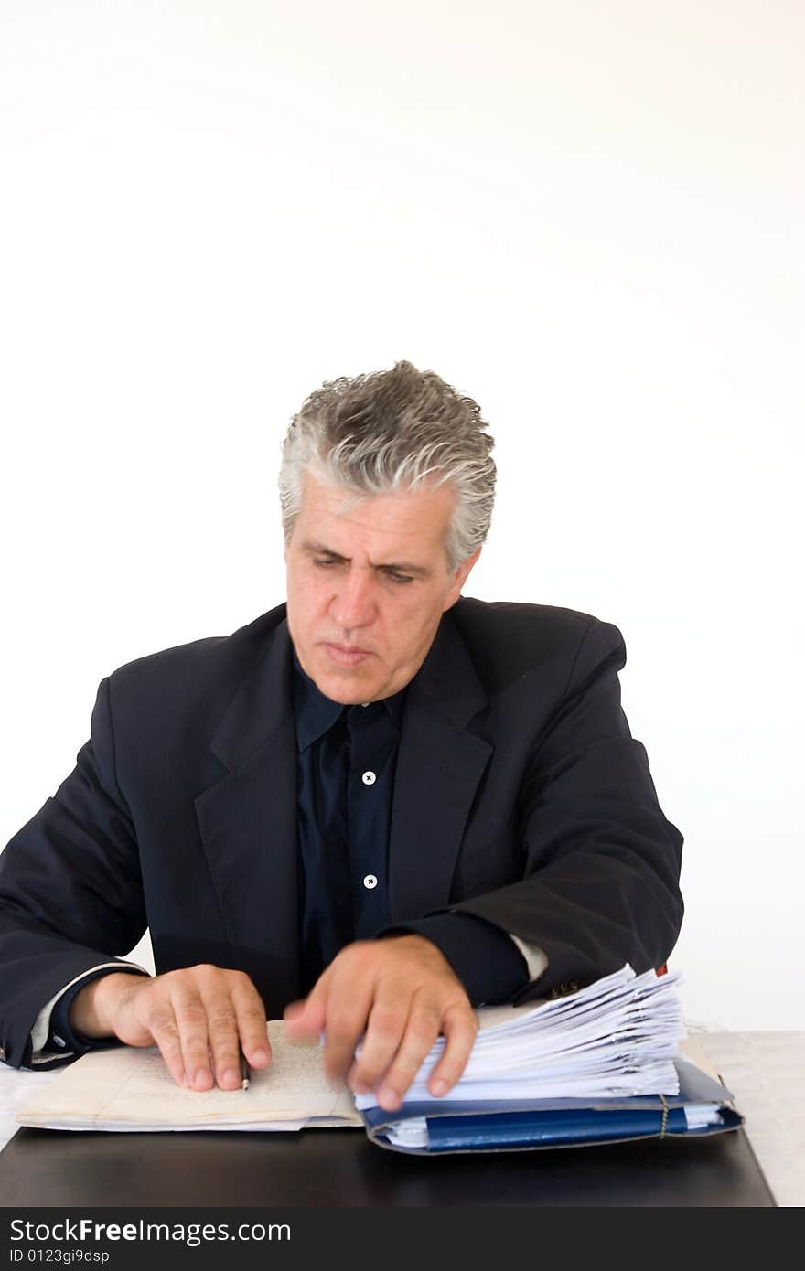 A businessman at work in his office writing a report