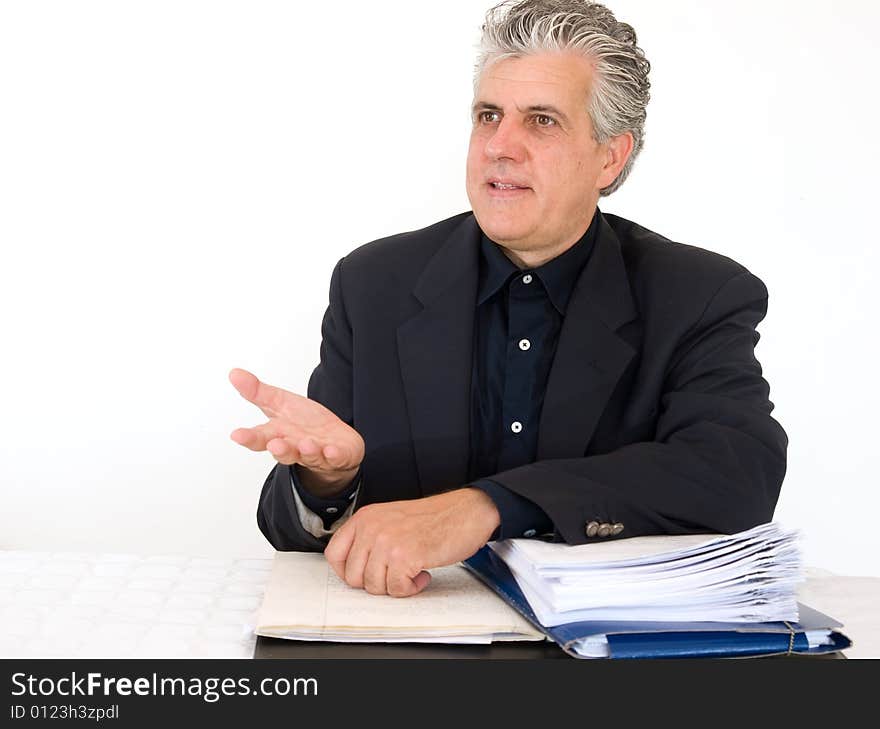 A businessman at work in his office in moment of the day.