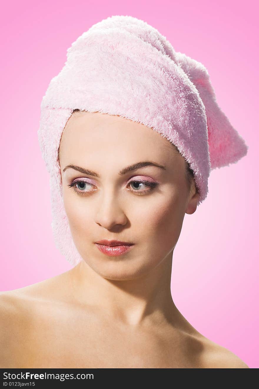 Beautiful woman wearing pink towel on her head