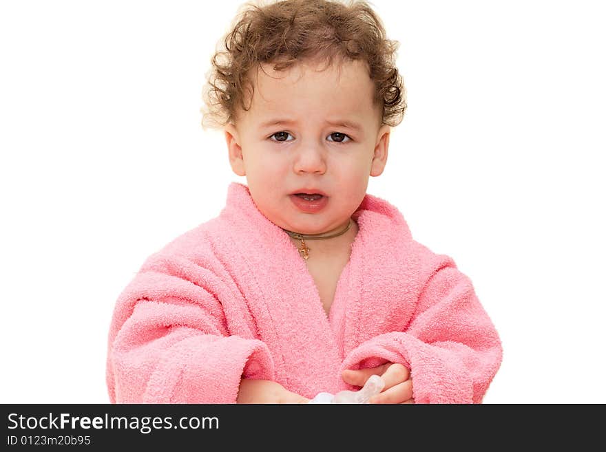 Small crying boy in a pink dressing gown