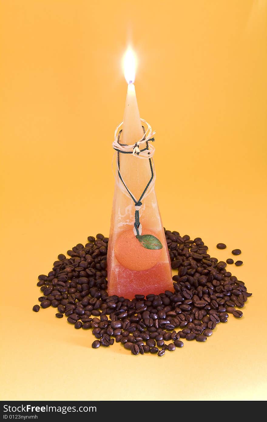 Orange candle with coffee beans