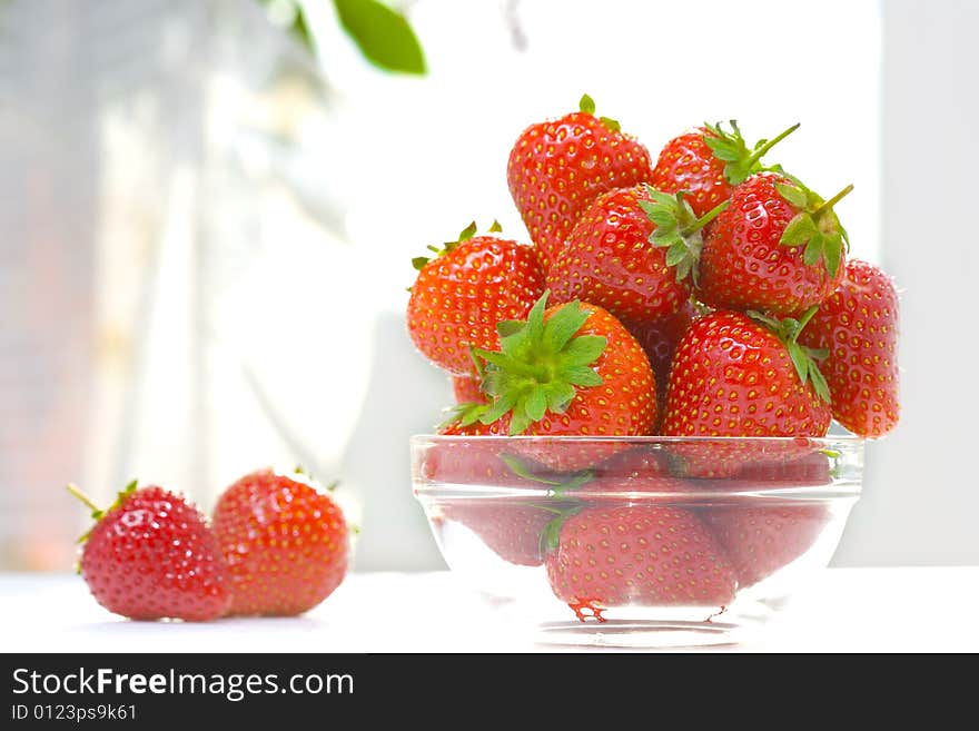 High key photo of fruit dish filled with nice red strawberries. High key photo of fruit dish filled with nice red strawberries