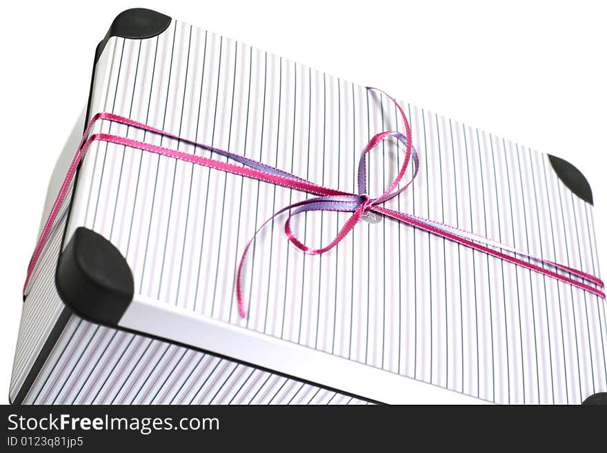 Close up of metal gift box with ribbon on white background