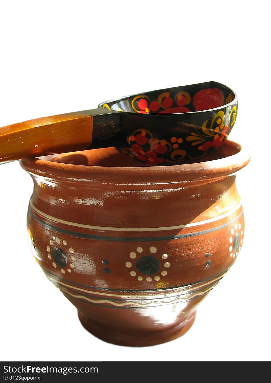 Russian earthenware glazed jug with wooden spoon. Russian earthenware glazed jug with wooden spoon