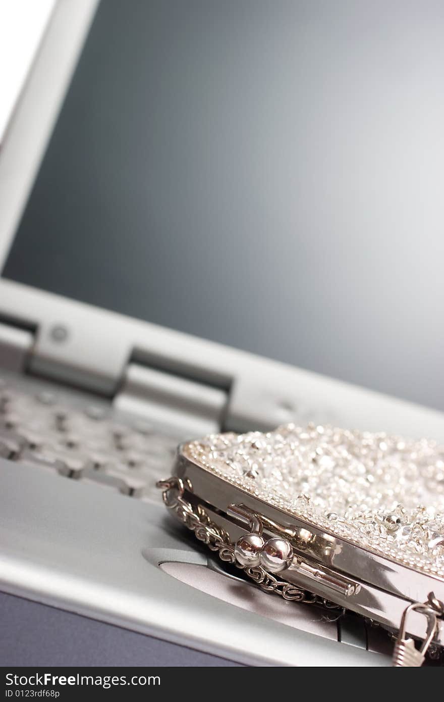 Laptop with woman's silver bag. Laptop with woman's silver bag