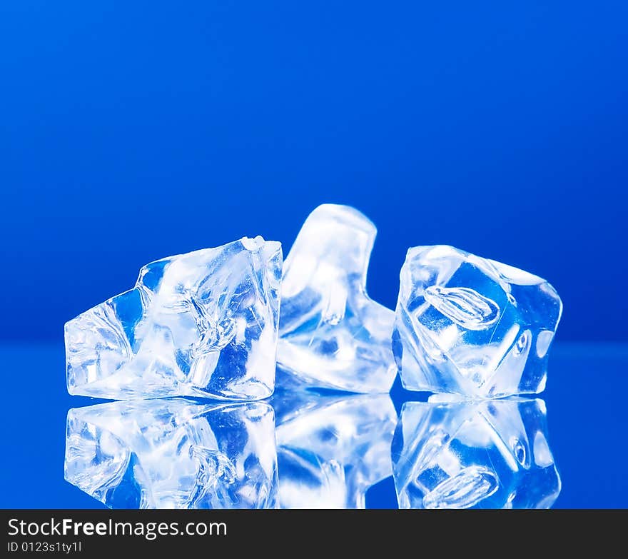 Close-up of ice cubes on blue