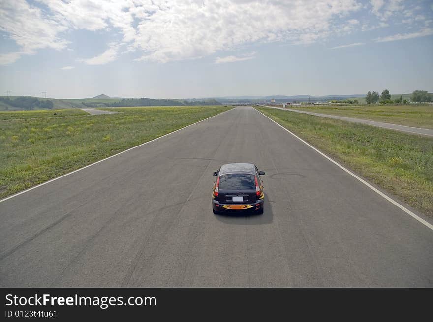 Small car on highway with.