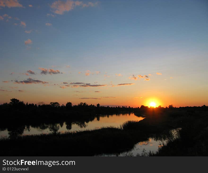 View of nice sunset on  river and the sky. View of nice sunset on  river and the sky