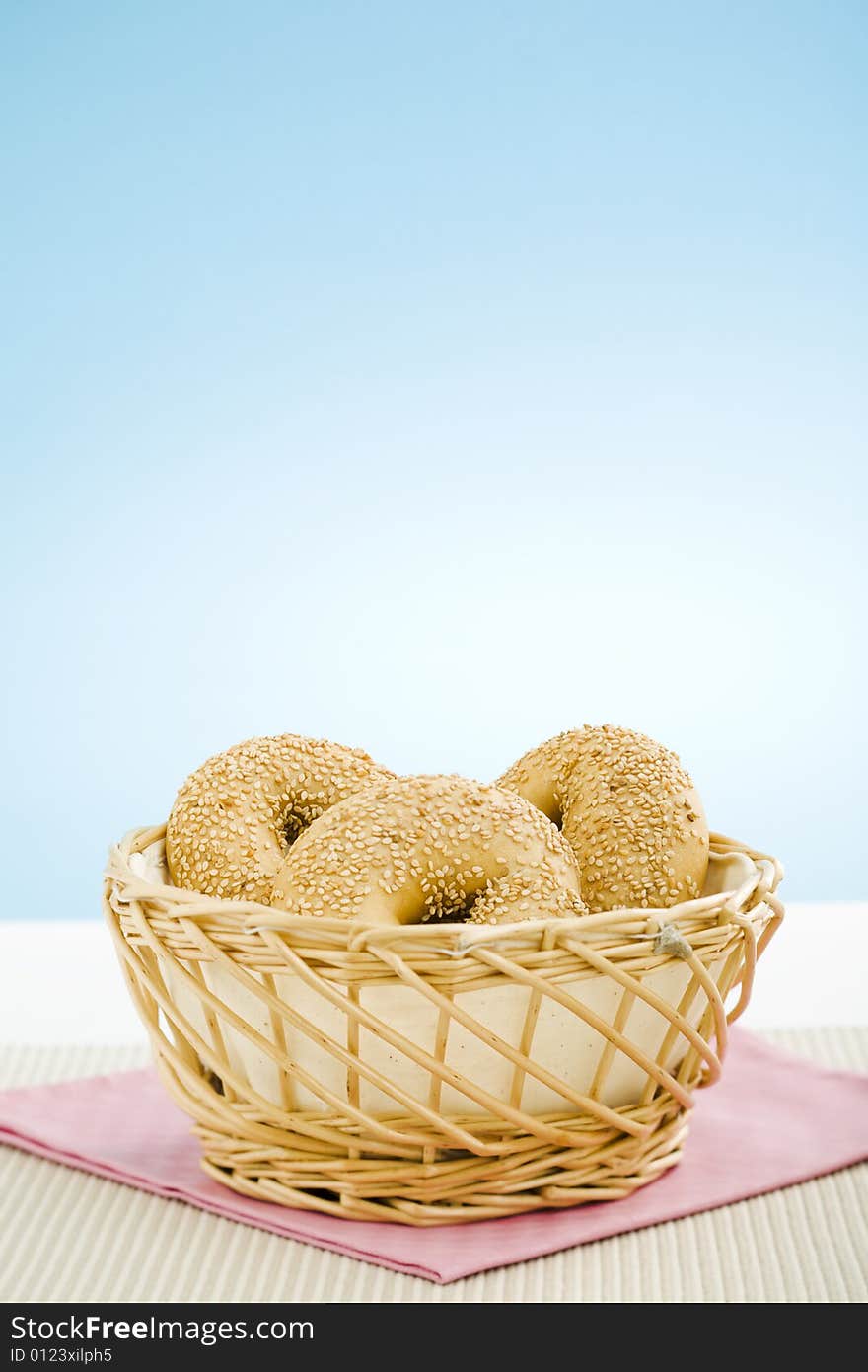 Breakfast bagels on the kitchen table over blue background