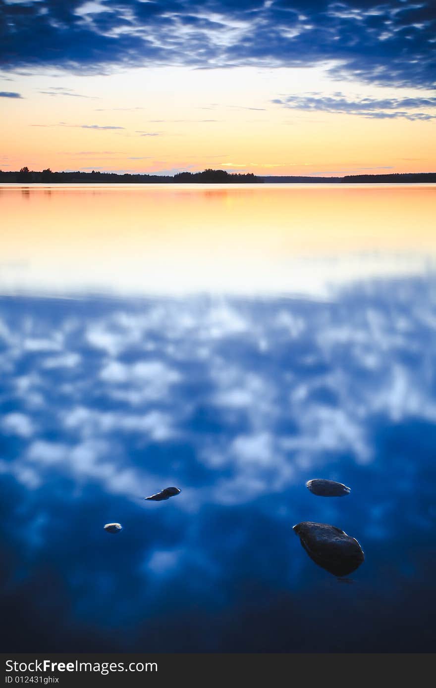 Sunset at lake with sky reflections on the water