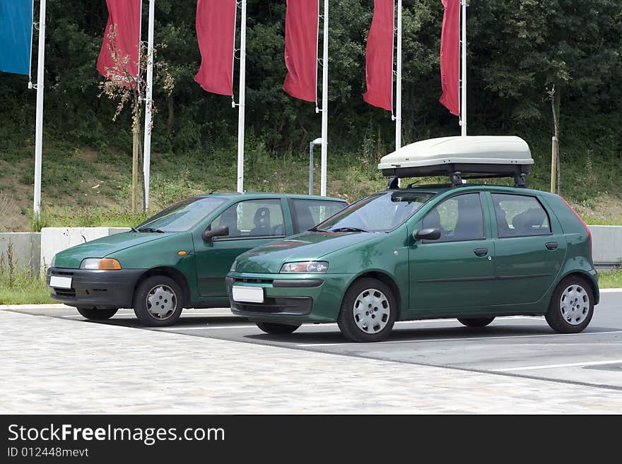 Green cars parked in a row