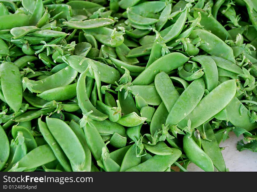 Pile of sugar peas at the farmer's market. Pile of sugar peas at the farmer's market.