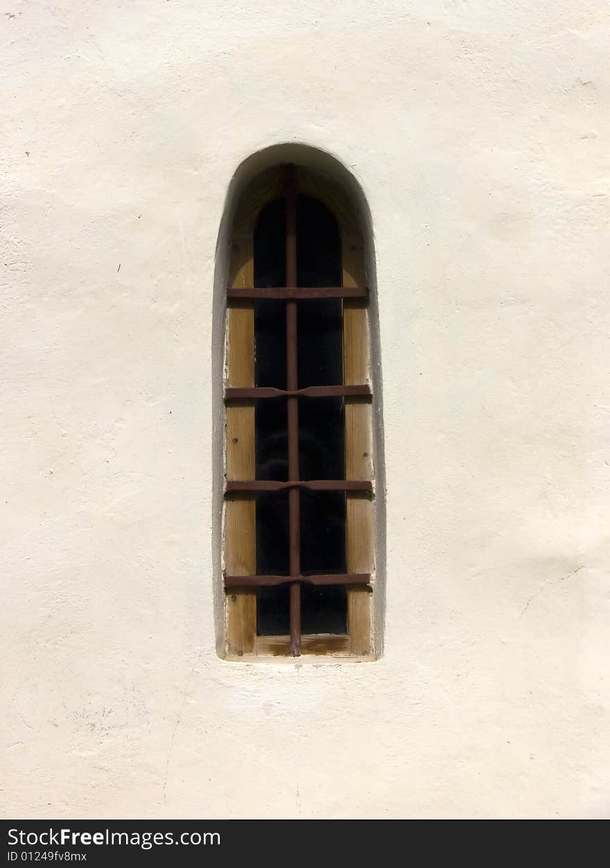 Old window in a wall of a church. Old window in a wall of a church