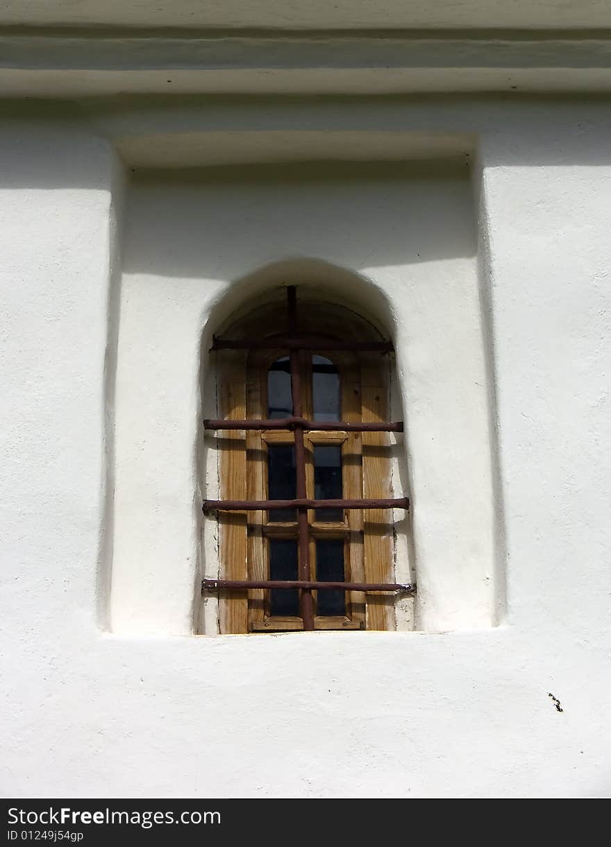 Old window in a wall of a church. Old window in a wall of a church