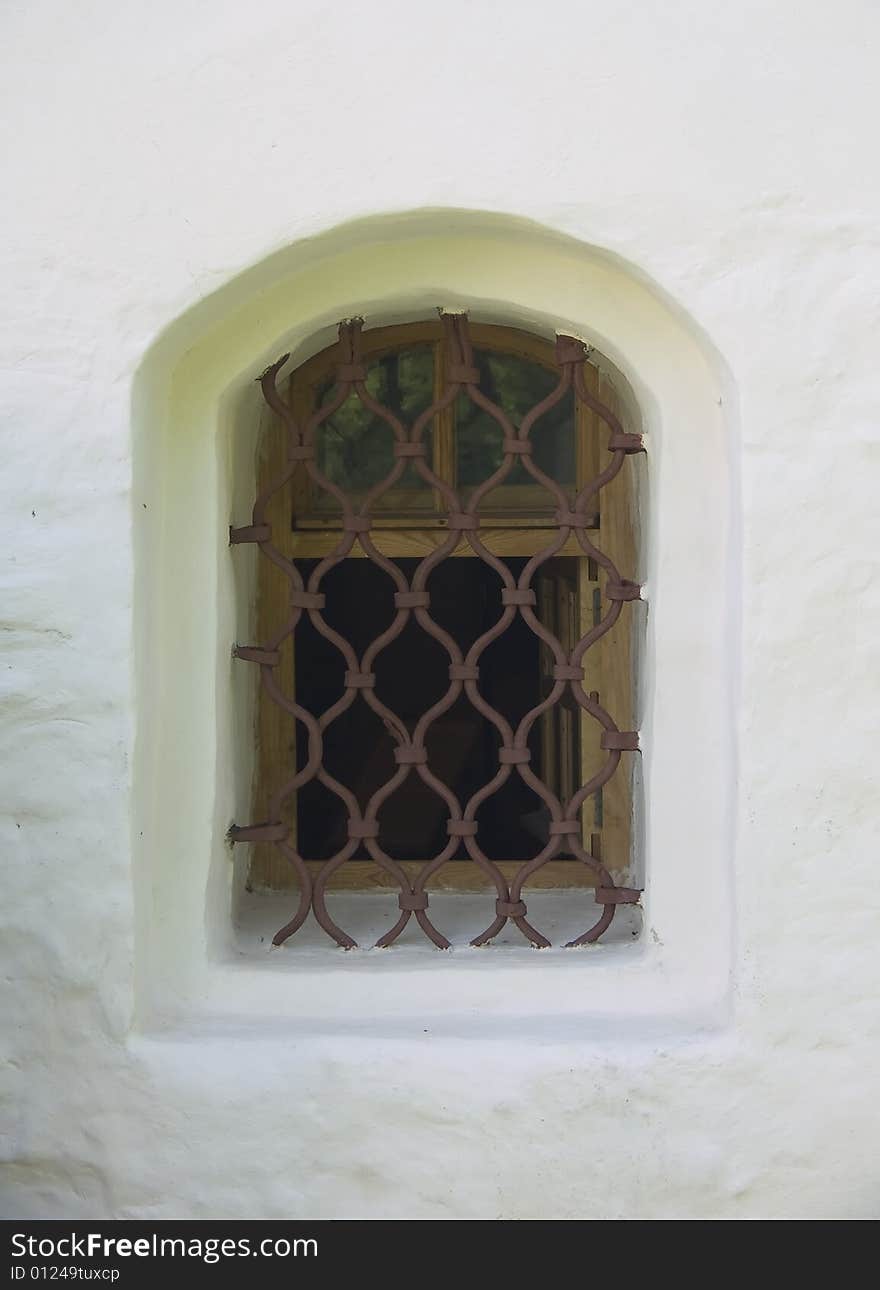 Old window in a wall of a church. Old window in a wall of a church