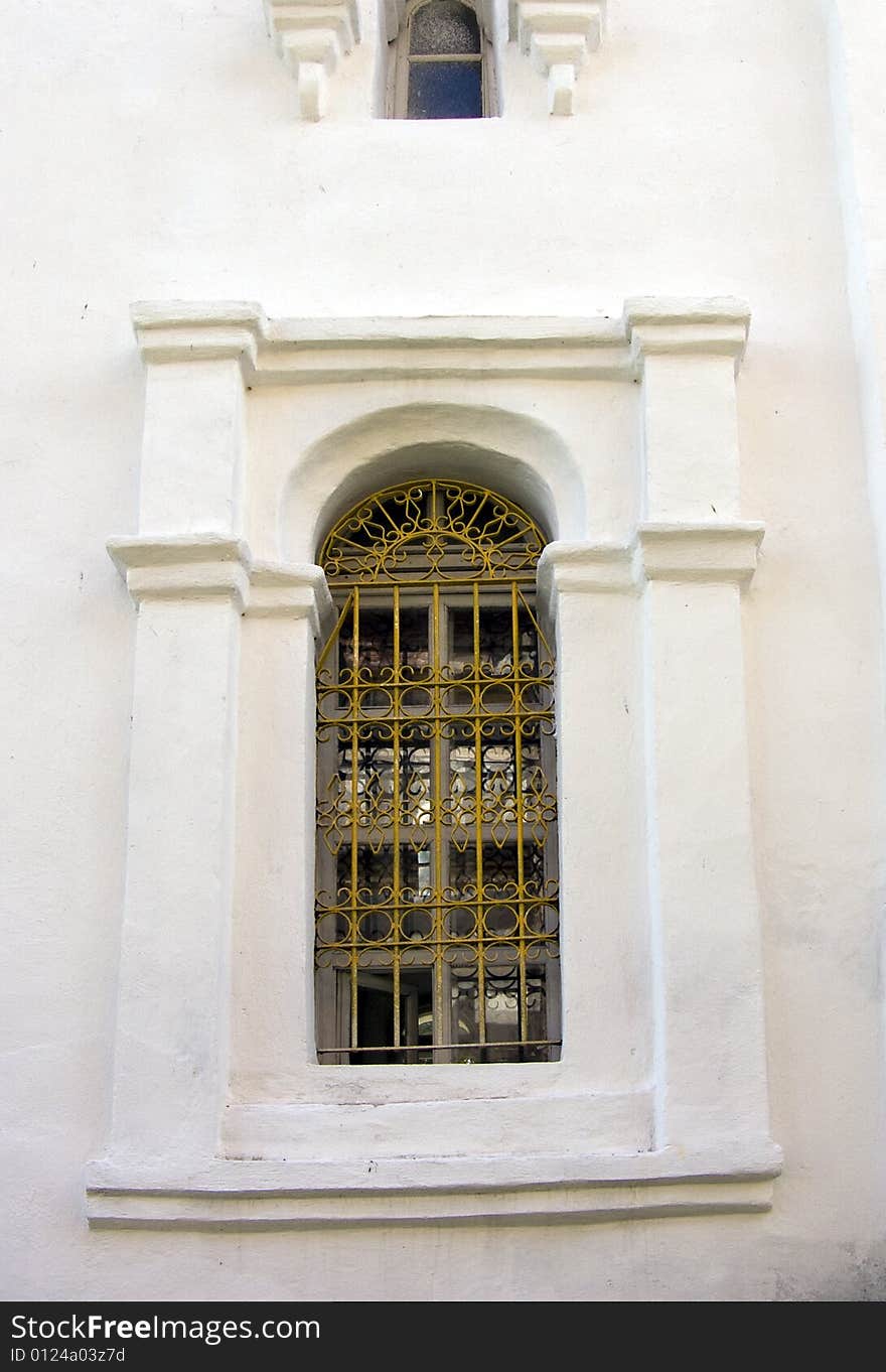 Old window in a wall of a church. Old window in a wall of a church