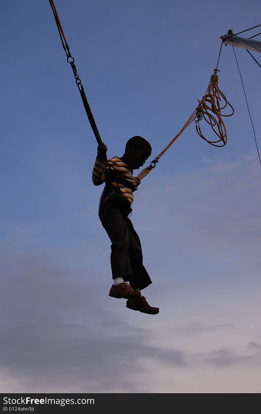 Little boy hanging in an amusement during the Africa day in Dublin. Little boy hanging in an amusement during the Africa day in Dublin