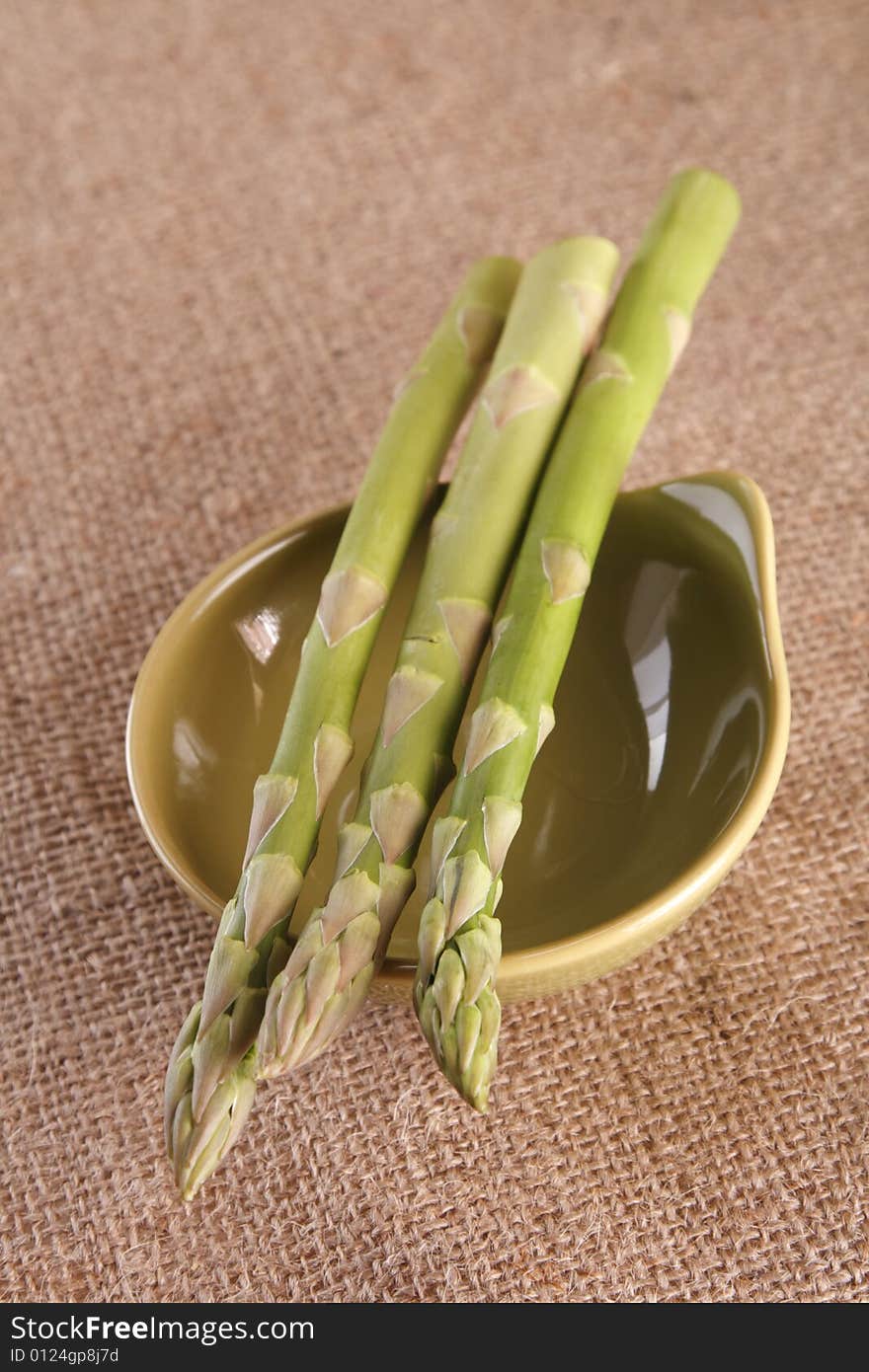 Fresh asparagus in a green bowl