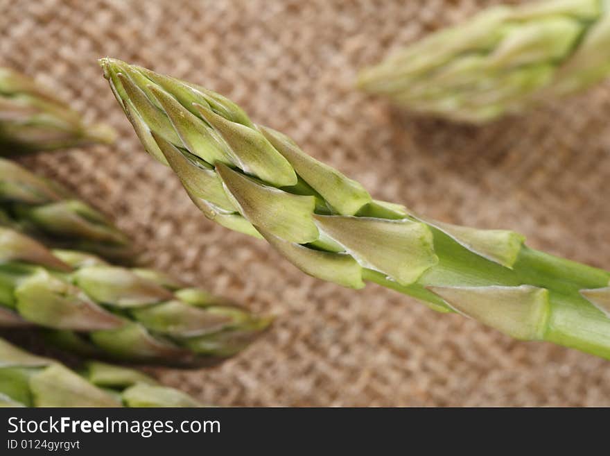 Fresh asparagus on hessian background