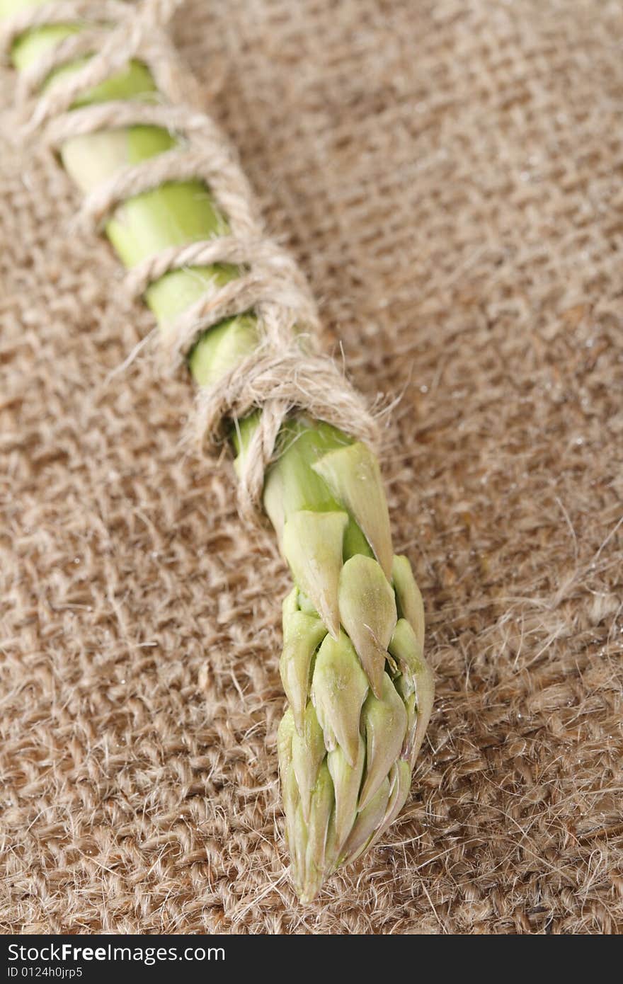 Fresh asparagus on hessian rag for background