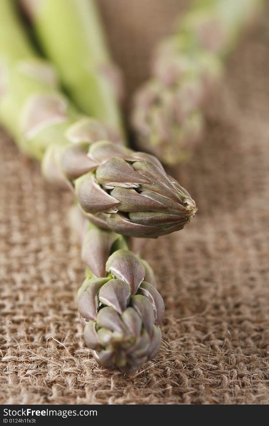 Fresh asparagus on hassian rag background