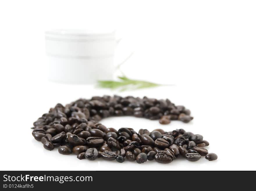 Closeup shot of letter C for coffee, against white background.  A cup and tarragon herb at background. Closeup shot of letter C for coffee, against white background.  A cup and tarragon herb at background.