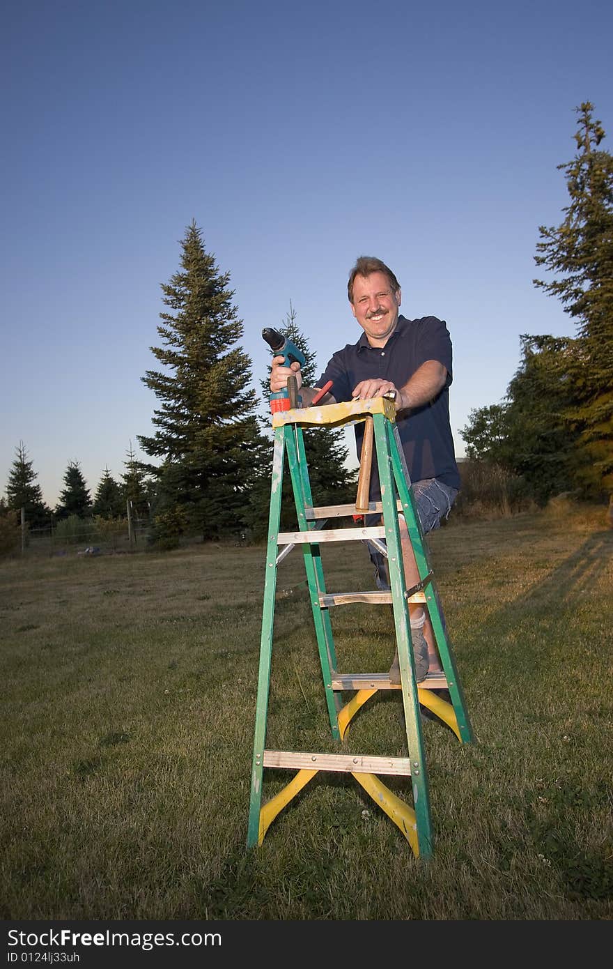 Man On Ladder - Vertical