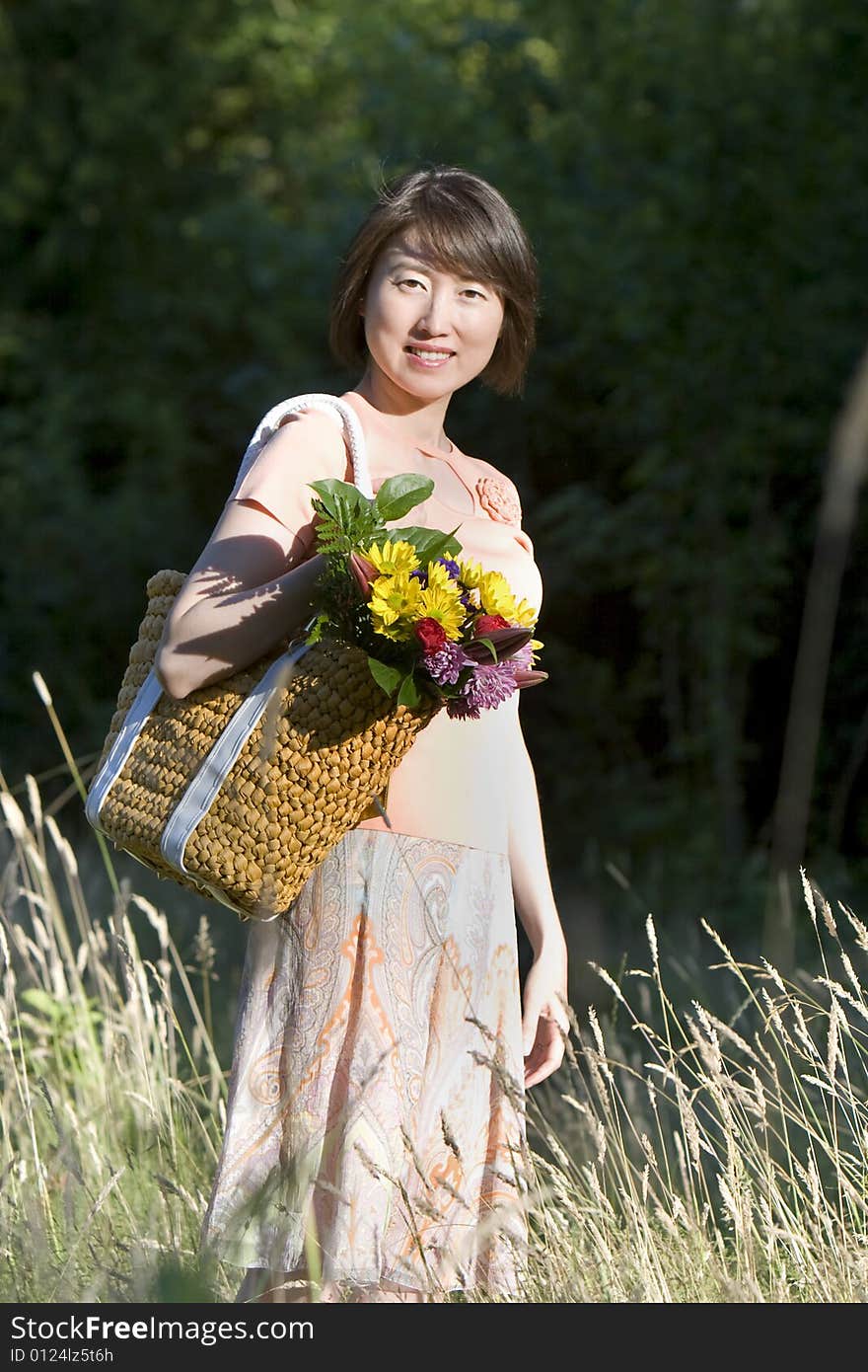 Woman in a Field of Grass Smiling - Vertictal