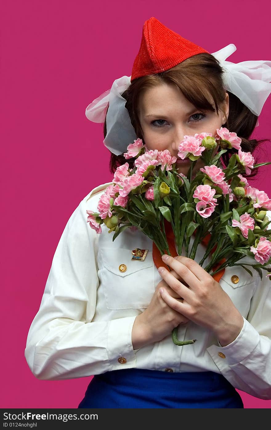 The pioneer with flower  on a pink background. The form of soviet time. The pioneer with flower  on a pink background. The form of soviet time