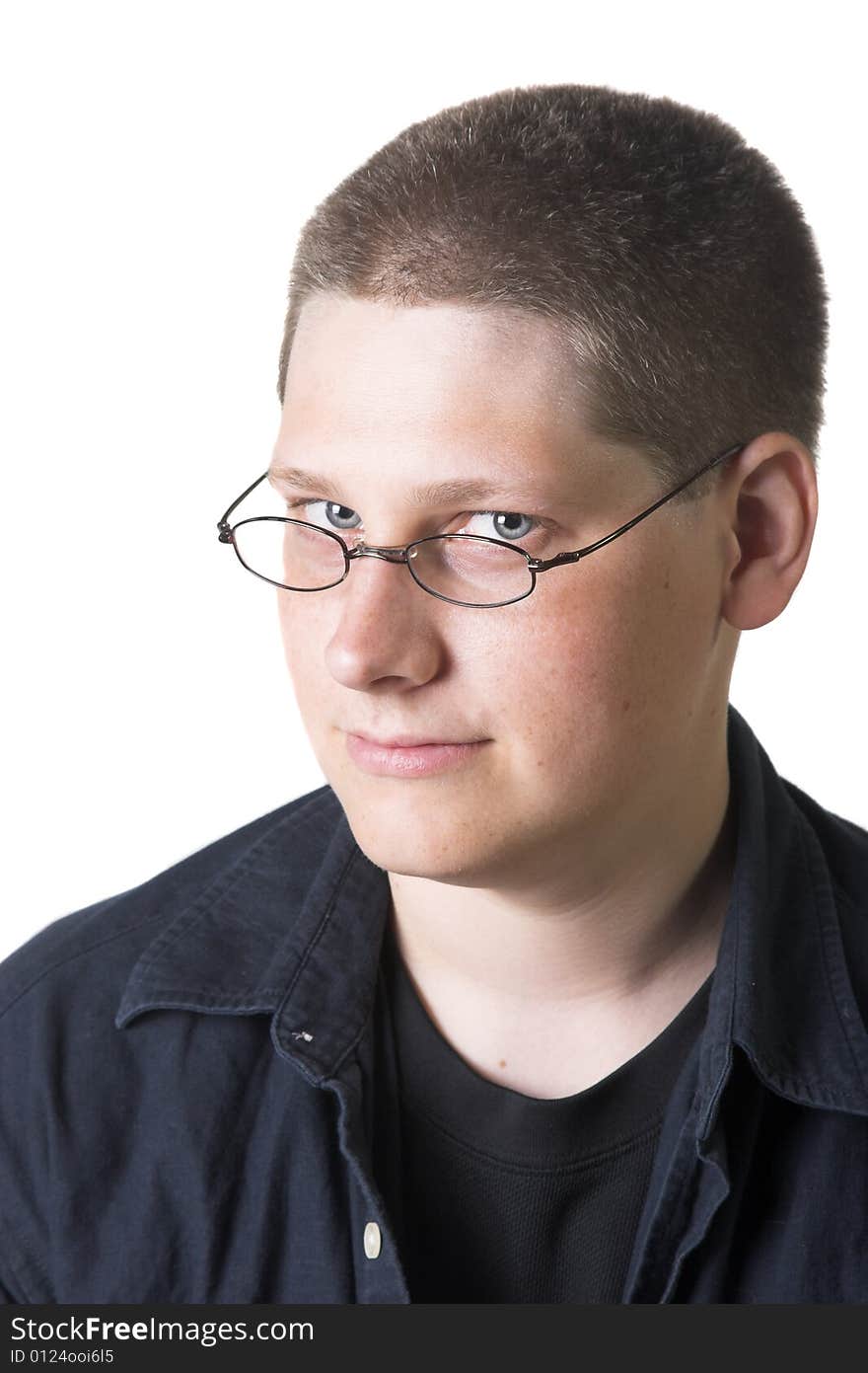 Young blond man with glasses against a white background.