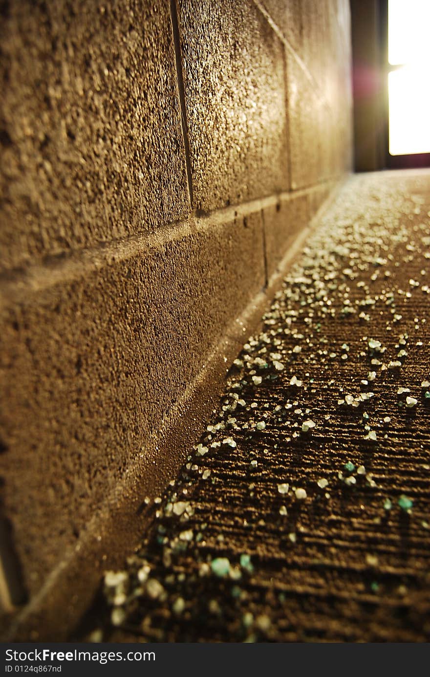 Broken glass scattered in a corner.