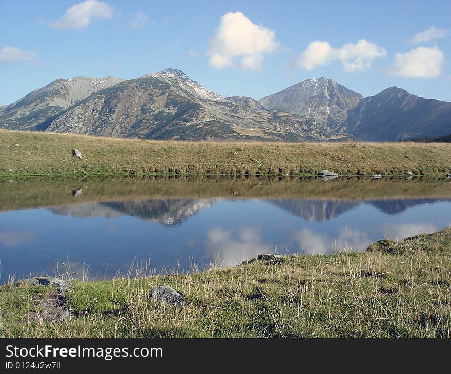 Mountain Range Reflected In The Water Retezat National Park. Mountain Range Reflected In The Water Retezat National Park.