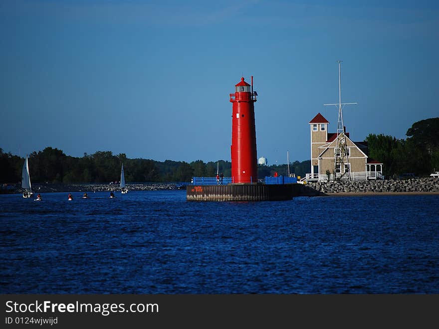 A lighthouse stands against the waives on this cool afternoon.