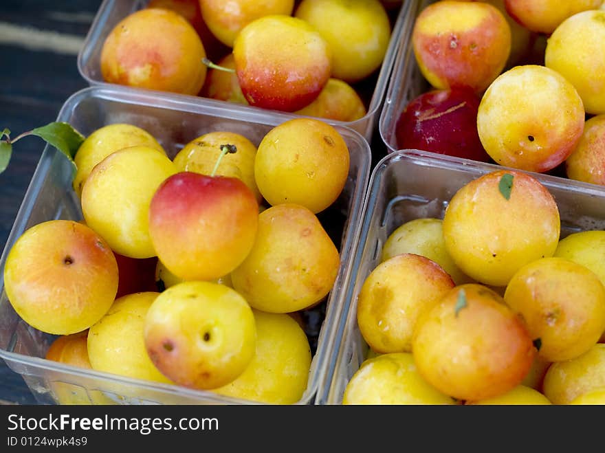 Close up shot of yellow and red Rainier cherries in clear plastic containers. Close up shot of yellow and red Rainier cherries in clear plastic containers.