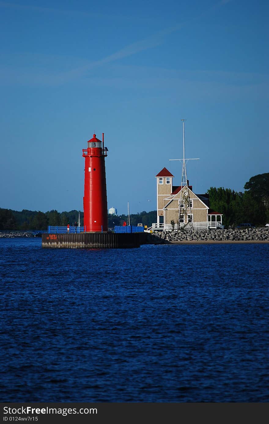 A lighthouse stands against the waves on this cool afternoon.