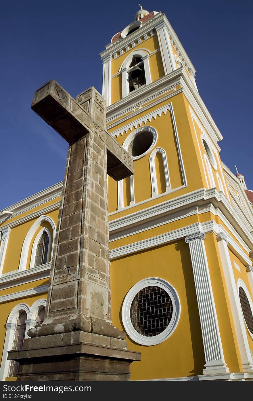 Stone cross next to the yellow cathedral in central Granada Nicaragua. Stone cross next to the yellow cathedral in central Granada Nicaragua