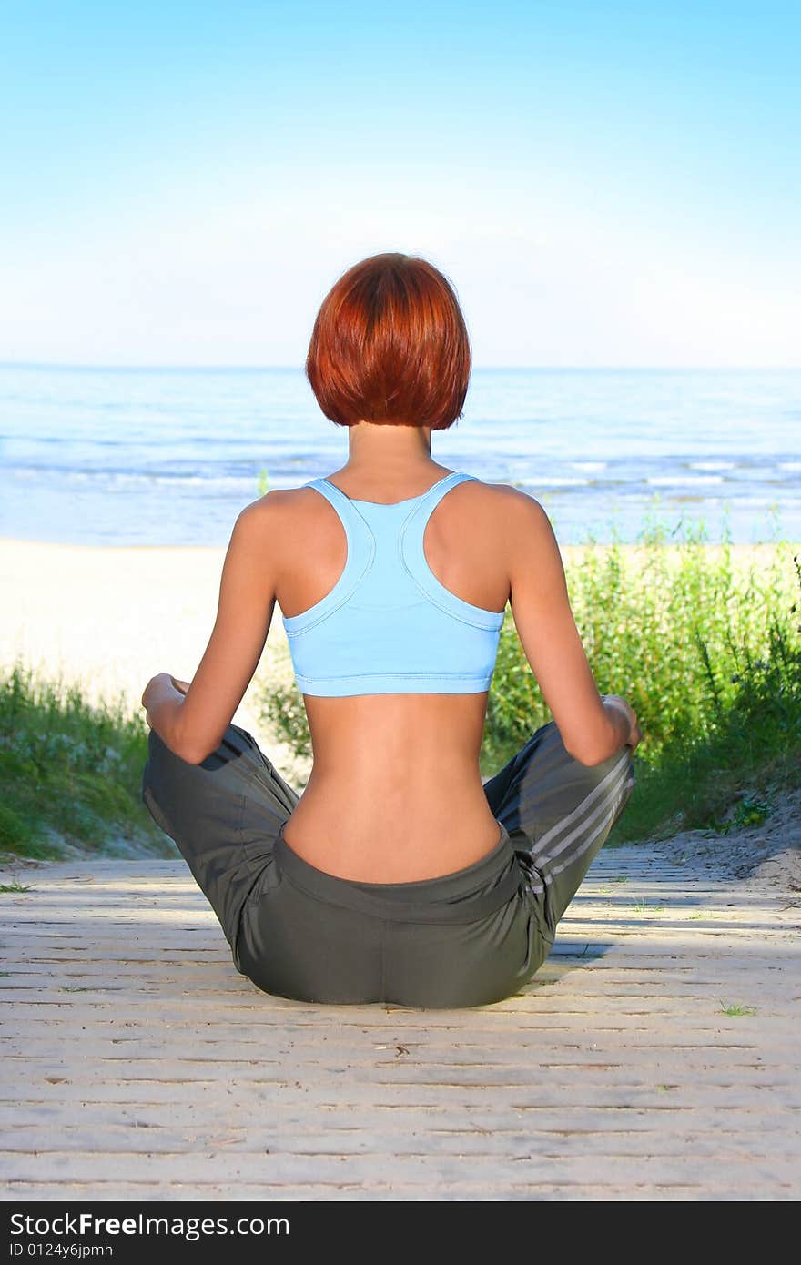 Young girl meditating on beach. Young girl meditating on beach