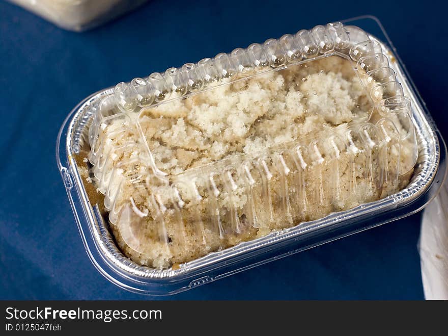 Strudel topped coffee cake for sale on a blue tablecloth. Strudel topped coffee cake for sale on a blue tablecloth.