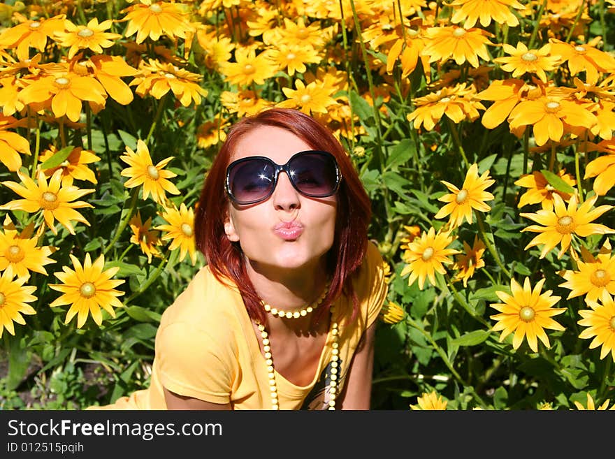 Funny redhead girl with yellow flowers