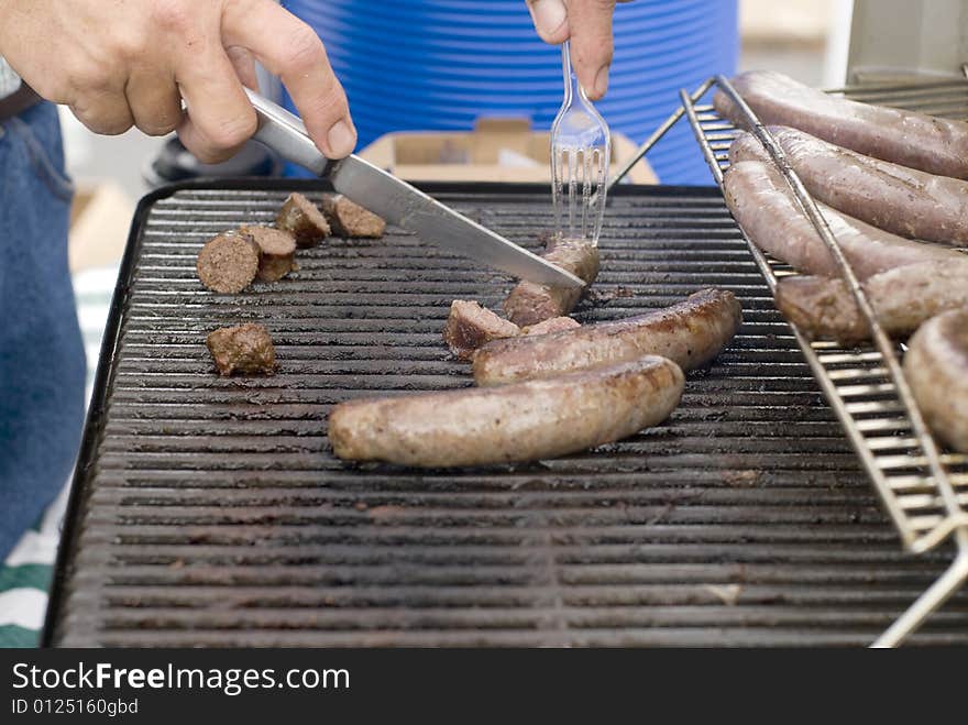 Italian sausages being grilled at a summer barbeque. Italian sausages being grilled at a summer barbeque.