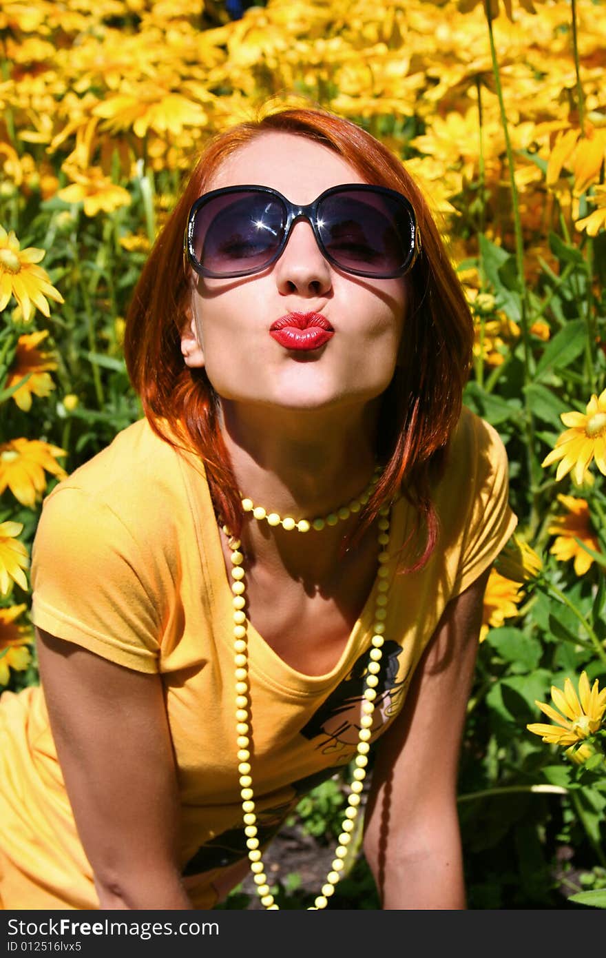 Funny redhead girl with yellow flowers