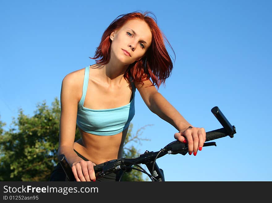 Slim girl on bicycle outdoors. Slim girl on bicycle outdoors