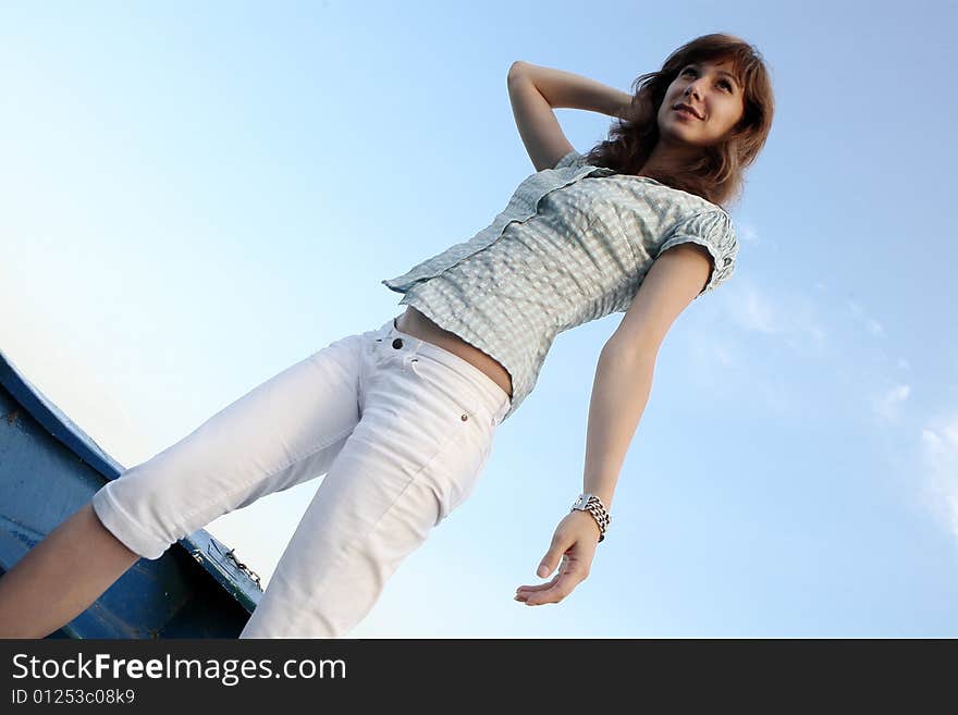 A young girl standing on a boat. A young girl standing on a boat