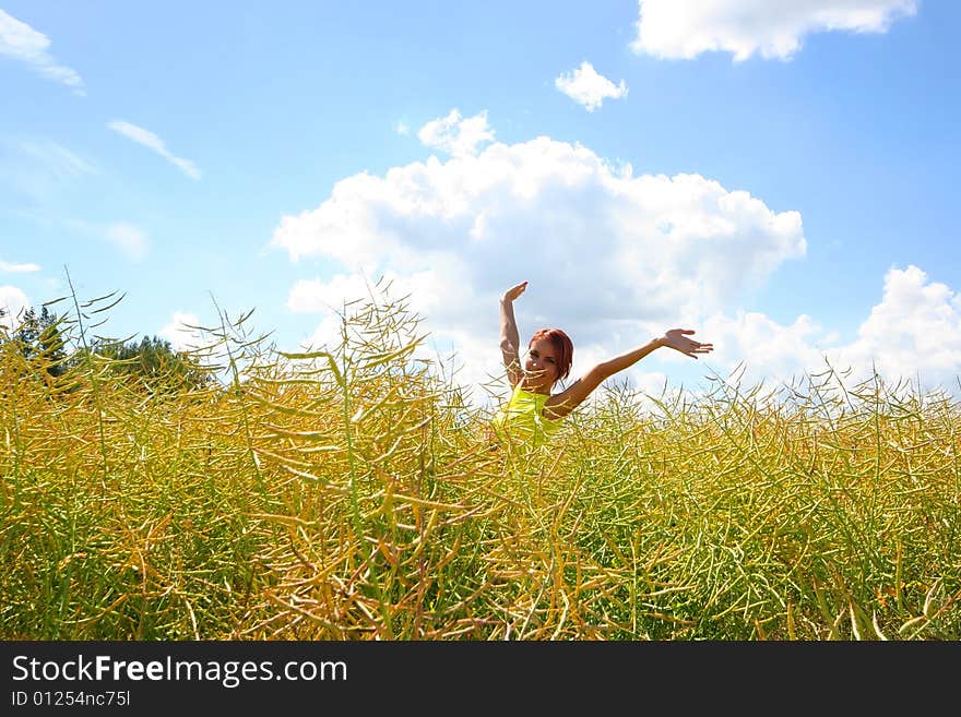 Happy young girl relaxing on yellow meadow. Happy young girl relaxing on yellow meadow