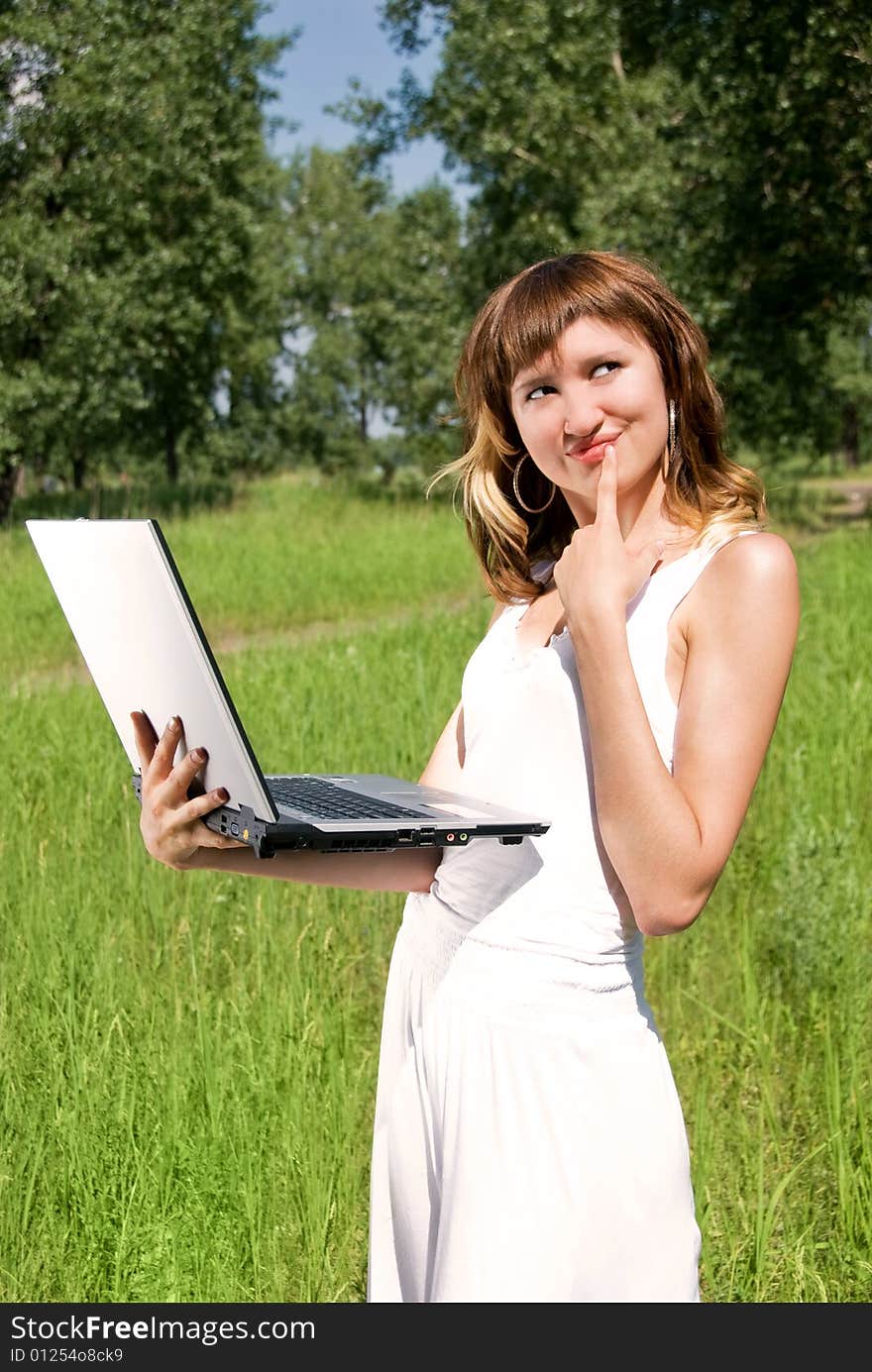 Beautiful young woman with a notebook outdoor. Beautiful young woman with a notebook outdoor