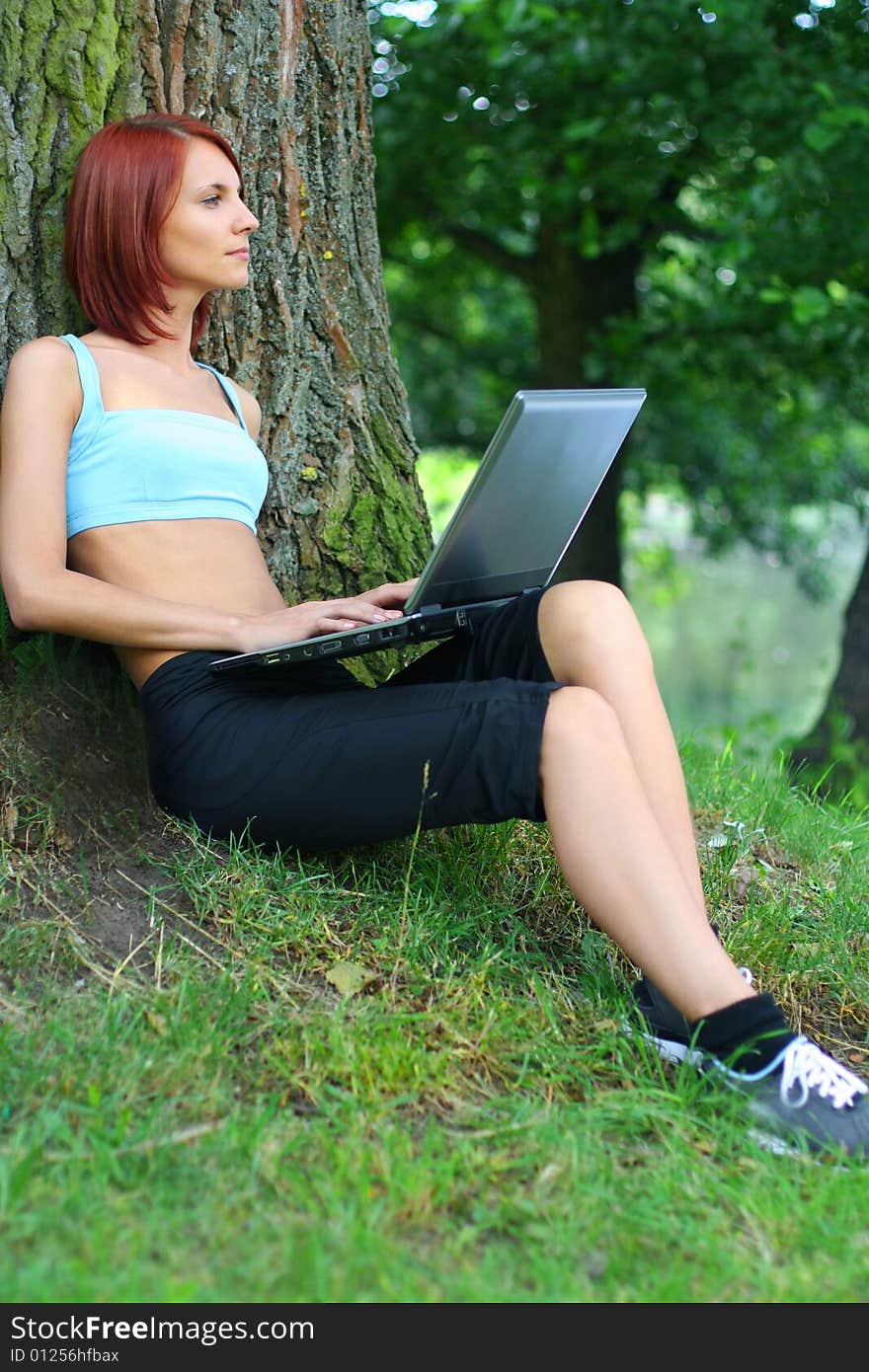 Cute young girl with laptop outdoors. Cute young girl with laptop outdoors