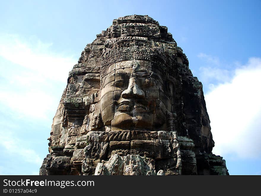 Huge carved face in ruins of temple in Cambodia. Huge carved face in ruins of temple in Cambodia