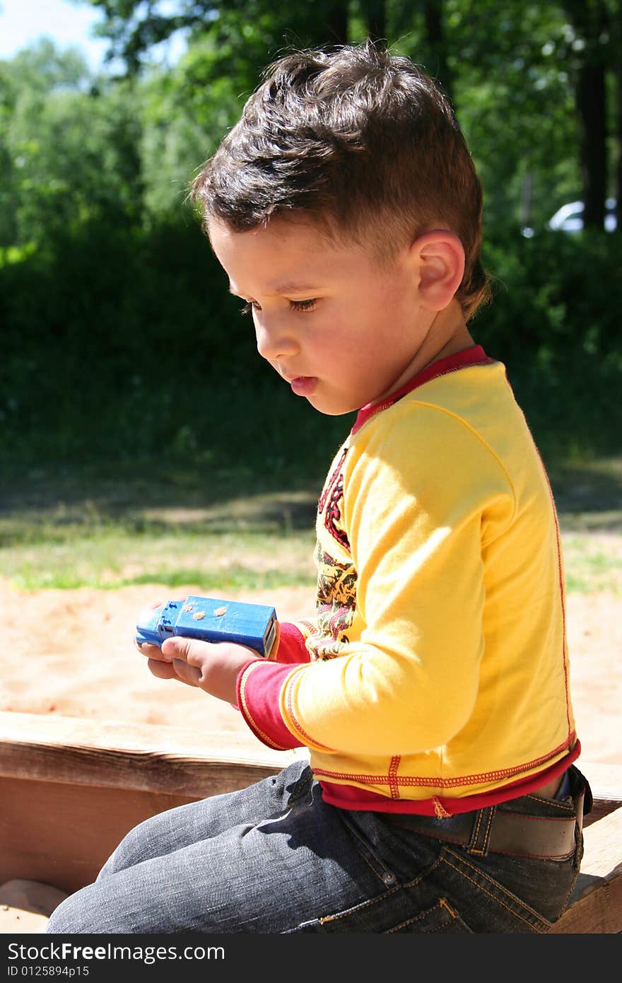 Little funny kid playing outdoors. Little funny kid playing outdoors